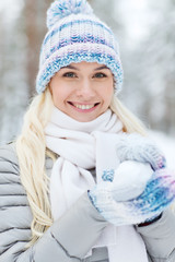 smiling young woman in winter forest