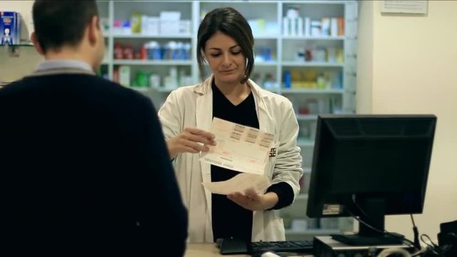 Pharmacist taking medicines for customer