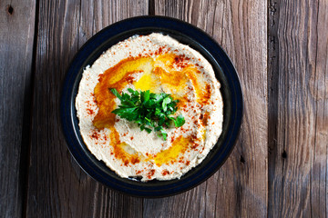 Fresh hummus with parsley and oil.