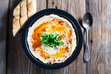 Fresh hummus with parsley and oil.