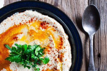 Fresh hummus with parsley and oil.