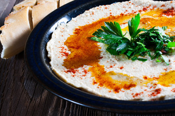 Fresh hummus with parsley and oil.