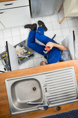 Plumber Repairing Sink