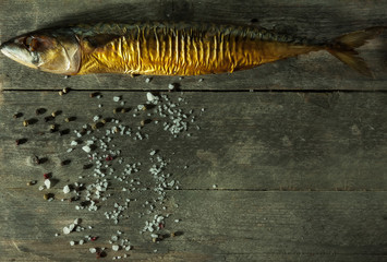 Smoked fish with spices on a rustic background