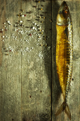 Smoked fish with spices on a rustic background