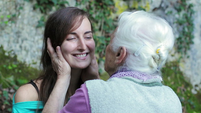Grandmother kiss her granddaughter