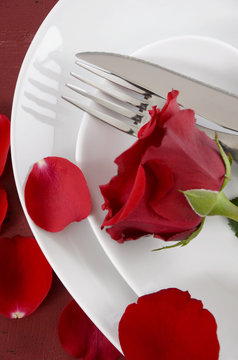 Valentines Day table place setting with red rose