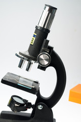Black microscope on a white background.