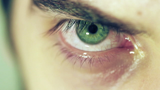 Detailed image of man's green eye with tears - cry