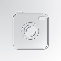 Old photocamera cut out icon on paper background