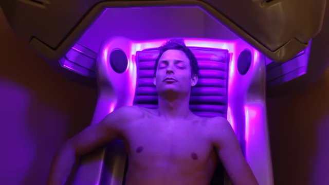 beautiful man sitting in a solarium