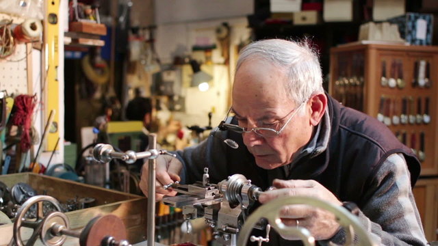 watchmaker working with a antique lathe