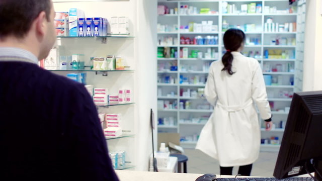 pharmacist taking medicines for customer