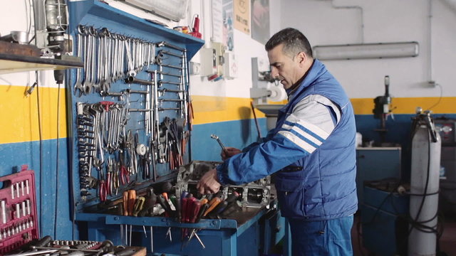 the work of Auto mechanic -  Auto mechanic  repairing a motor - dolly