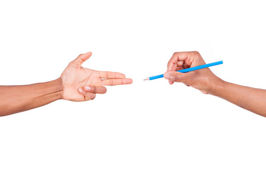 Isolated African Hand Making Gun Gesture To A Hand Holding A Pen