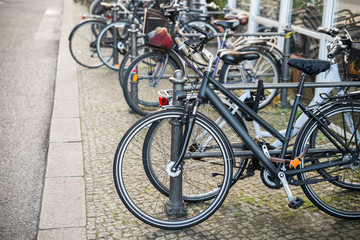 Fototapeta na wymiar Bicycles Parked Against A Railing