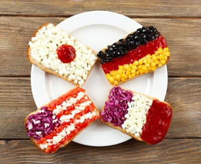 Sandwiches with  different flags on table close-up