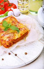 Portion of tasty lasagna on table