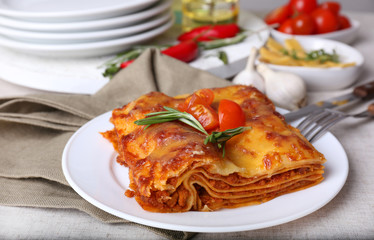 Portion of tasty lasagna on table