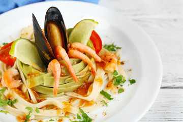 Tasty pasta with shrimps, mussels and tomatoes