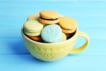 Assortment of gentle colorful macaroons in colorful mug
