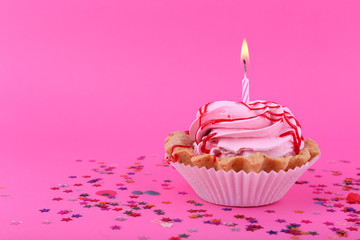 Birthday cup cake with candle and colorful stars