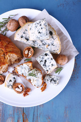 Blue cheese with sprigs of rosemary, bread and nuts