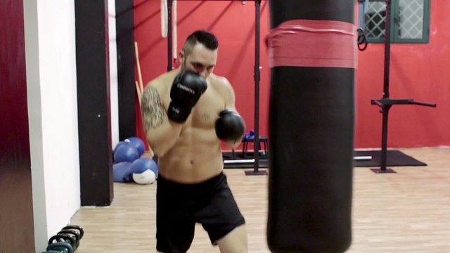 boxer trains with the punching bag - boxe