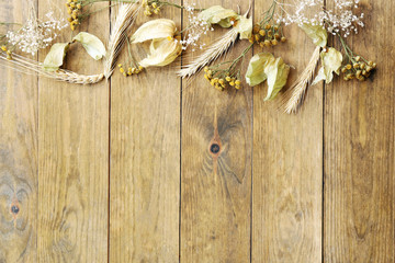Dried wheat on rustic wooden planks background