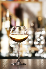 Glass of wine with bar on background