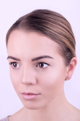 Obraz premium Applying makeup on female face, isolated on white