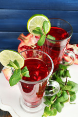 Pomegranate drink in glasses with mint and slices of lime