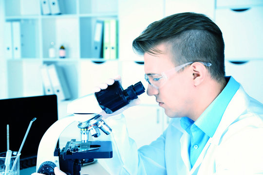 Young male researcher carrying out scientific research in lab