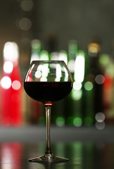 Glass of red wine in bar on blurred background