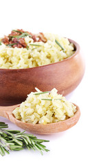 Rice with walnuts and rosemary in plate isolated on white