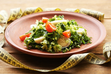 Salad with quail egg and basil in plate