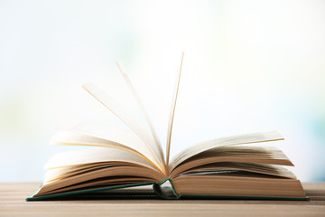 Open book on blurred bright background