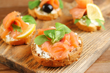 Canapes with salmon, black olive and herbs