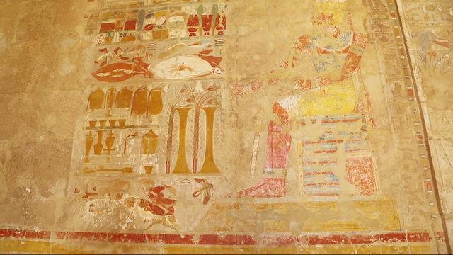 ancient egypt color images on wall in luxor - tilt view