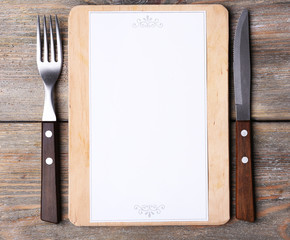 Cutting board with menu sheet of paper