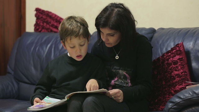 Mom is helping her son to do homework of the school