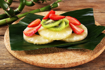 Fruit dessert on green leaf on table