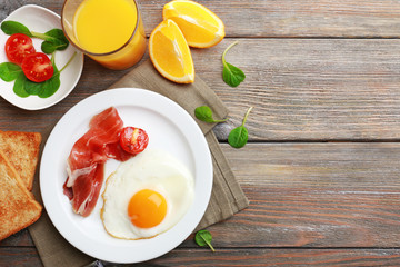 Bacon and eggs on rustic wooden planks background
