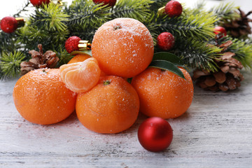 Fototapeta na wymiar Christmas composition with tangerines on wooden background