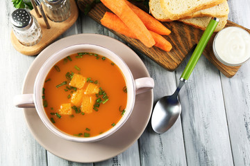 Composition with carrot soup, ingredients and herbs