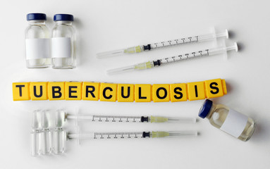 Tuberculosis word and medical equipment on light background