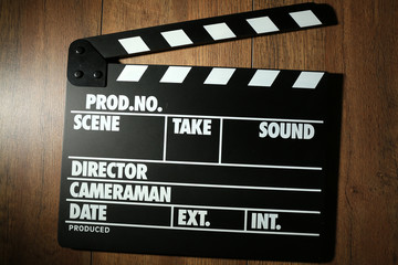 Movie clapper on wooden background