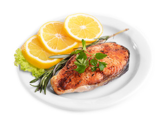 Tasty baked fish on plate isolated on white