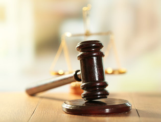 Wooden judges gavel on wooden table, close up
