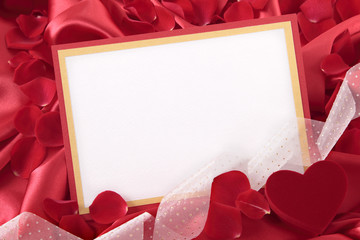 Valentine card with ribbon, gift box and rose petals
